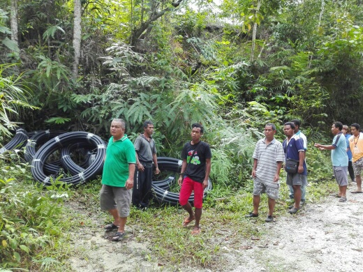 Kg Sinju villagers and SOA bringing pipes into hills